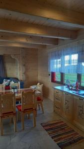 a kitchen and dining room with a table and chairs at Bachledowy Wierch in Czerwienne
