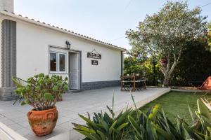 a backyard with a pool and a house at Casa das Laranjeiras in Alfarim