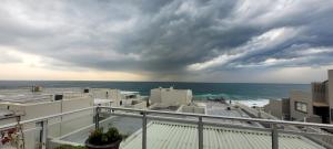 a view of the ocean from the balcony of a building at Sunseaker- Beachfront Complex in Ballito