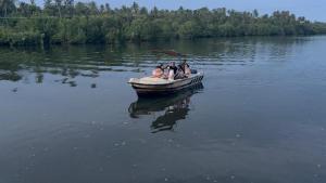 a group of people in a boat on a lake at Natural Lake Down South in Habaraduwa