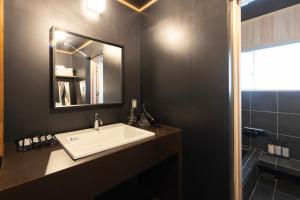a bathroom with a white sink and a mirror at 博多町家小箱 in Fukuoka +43 photos