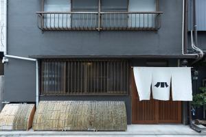 a pair of towels hanging on a building at 博多町家小箱 in Fukuoka