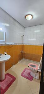 a bathroom with a pink toilet and a sink at privat Room in Shard Appartement step by mosquée Hassan 2 in Casablanca