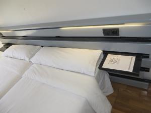 a hotel room with a bed and a lamp at Toctoc Rooms in A Coruña