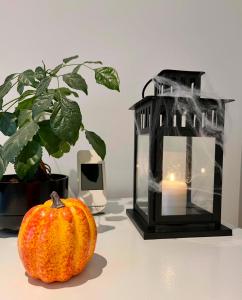 a pumpkin sitting on a table next to a candle at Family Stay & 20 min Disneyland Paris in Meaux