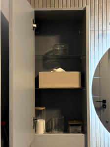 a kitchen pantry with black shelves at Central Apartment in Zetea +26 photos