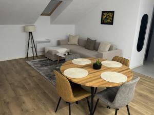a living room with a table and a couch at Central Apartment in Zetea