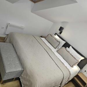 a white bed with pillows and a lamp in a bedroom at Central Apartment in Zetea