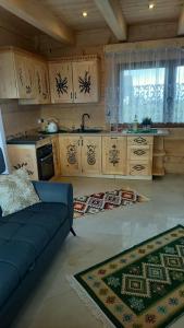 a living room with a couch and a kitchen at Bachledowy Wierch 2 in Czerwienne +27 photos