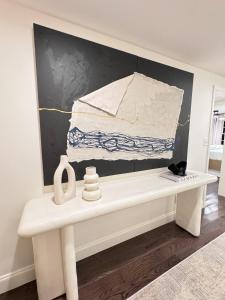 a white bench in a room with a painting on the wall at Modern Farmhouse at Montaluce Winery in Dahlonega