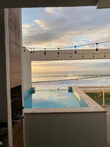 a view of the ocean from the balcony of a house at Pousada dos Sonhos Costa Azul in Rio das Ostras