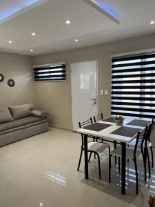 a living room with a table and chairs and a couch at Atardecer Aparts in Escalante