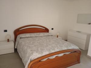 a bedroom with a wooden bed and two night stands at Casa Iole in Monte Isola
