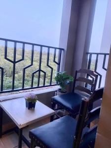 a balcony with two chairs and a table and a window at GoldenSpark Homes in Thika