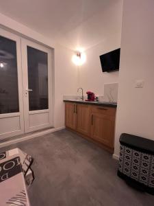 a room with a kitchen with a sink and a window at CinémaRoom Béziers in Béziers +12 photos