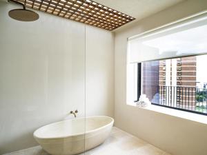 a bathroom with a tub and a large window at Mercure Benidorm in Benidorm +165 photos