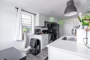 a kitchen with white cabinets and a black appliances at Short North Convention Private Parking Pets! in Columbus