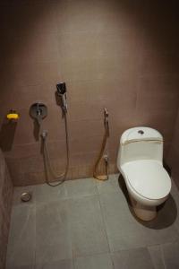 a bathroom with a toilet and a shower at Luxury cozy studio apartment with balcony in Lahore +11 photos