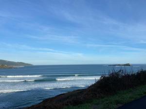 a view of the ocean from a beach with waves at LAIDA BEACH by Urdaibai Experience in Ibarrangelu