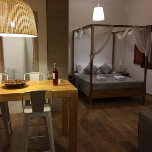1 dormitorio con cama, mesa, cama y mesa de comedor en Apocalypsis Houses en Skála
