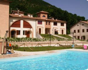 a large house with a swimming pool in front of it at Residence con Piscina Vista Monte Nerone in Piobbico