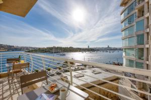a balcony of a building with a view of the water at Stunning Seafront Apartment with Panoramic Views in Sliema