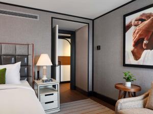 une chambre d'hôtel avec un lit et une chaise dans l'établissement 21c Museum Hotel St Louis, à Saint-Louis