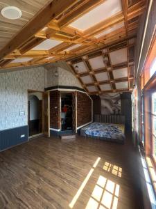 a large room with a bed and a brick wall at The Mool Farm and Living in Tangmarg