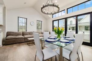 a dining room with a glass table and white chairs at Short North Convention Garage Parking! in Columbus