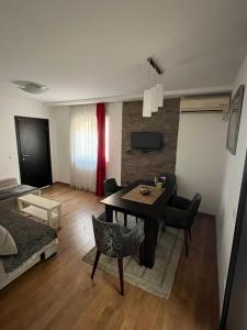 a small living room with a table and chairs at 2BR Apartment Gaga near Airport W Airport Shuttle in Surčin