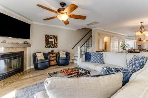 a living room with a couch and a ceiling fan at Seabreeze village 3 in Dewey Beach