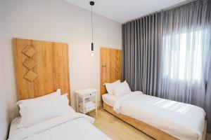 a bedroom with two beds and a window at Mabaat-White Pearl Compound 600 C Villa 24 in Jeddah