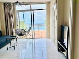 a living room with a view of the ocean at First-Line Las Canteras Beach in Las Palmas de Gran Canaria