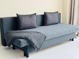 a blue couch with a blanket on top of it at First-Line Las Canteras Beach in Las Palmas de Gran Canaria