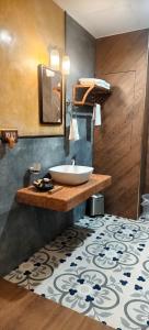 a bathroom with a sink and a mirror at Marari Beach Bungalow Resort Alleppey in Mararikulam