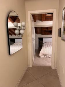 a bedroom with a mirror and a bed at Carpi piazza del castello in Carpi