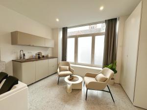 a living room with two chairs and a table at L'intemporel - Balneo, Cozy, Romantic in Lambersart