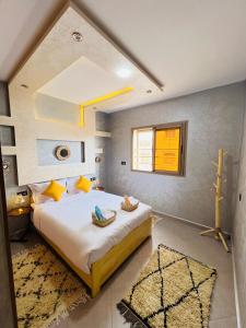 a bedroom with a large bed in a room at Tadinga Surf House in Imsouane