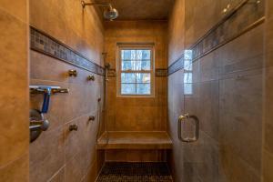 a bathroom with a walk in shower and a window at Peaceful Wood Haven at Mill Ridge in Banner Elk +40 photos