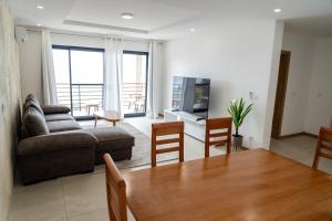 a living room with a couch and a table and chairs at o som das ondas in Praia