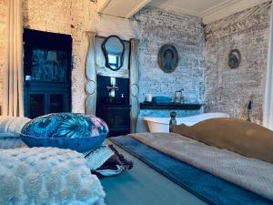 a bedroom with a bed and a tub and a sink at Legions Lodge in Antwerp +7 photos