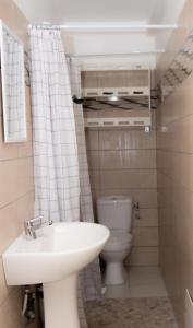 a small bathroom with a sink and a toilet at Gosier séjour in Le Gosier +5 photos