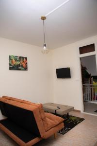 a living room with a couch and a table at Gosier séjour in Le Gosier
