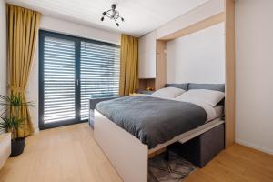 Ένα ή περισσότερα κρεβάτια σε δωμάτιο στο NEW Comfort Business Apartment