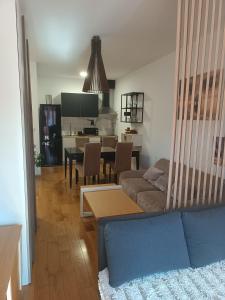 a living room with a couch and a table at Apartman Markovic Rich in Loznica