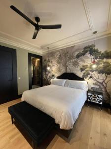 a bedroom with a large bed with a ceiling fan at DREAMS by Urdaibai Experience in Bilbao