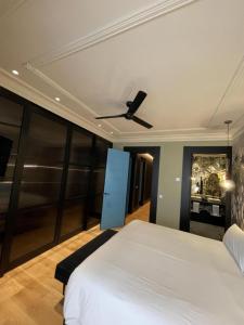 a bedroom with a bed and a ceiling fan at DREAMS by Urdaibai Experience in Bilbao +2 photos
