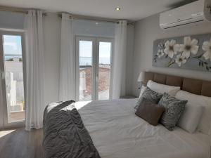 a bedroom with a large bed with a large window at Casa Paula Apartments in Lagos