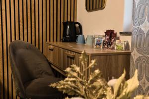 a chair sitting next to a counter in a room at Lux room 5 & ljubljana in Ljubljana