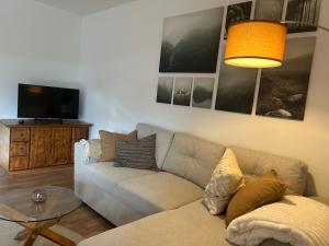 a living room with a couch and a table at Ferienwohnung Bergische Auszeit in Gummersbach